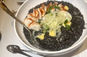 Hummerschwanz-Risotto mit Tintenfischtinte, dazu Aioli, Fenchel und Safranöl.